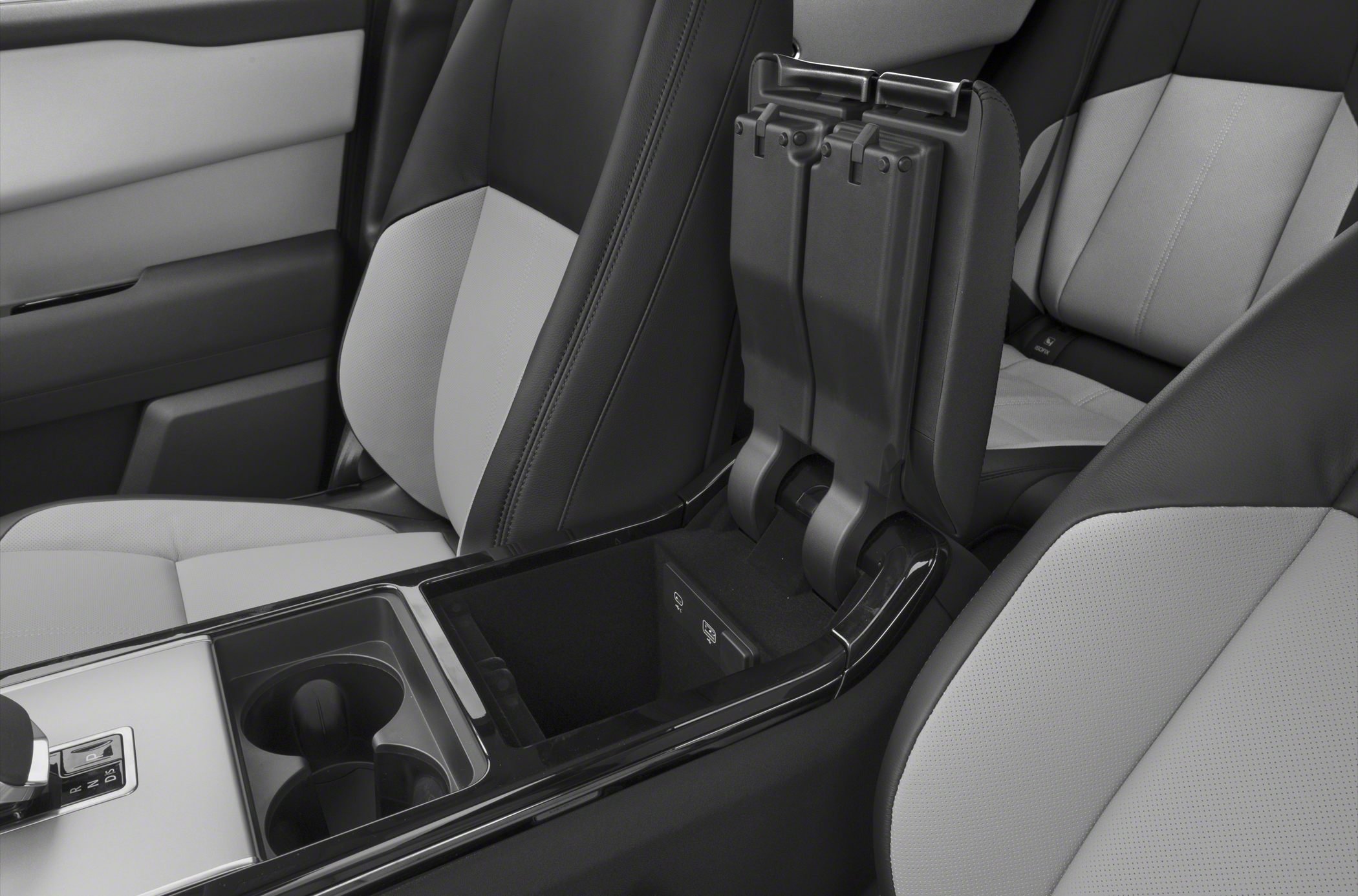 Luxury center console with armrest storage and cup holders, premium two-tone seats.