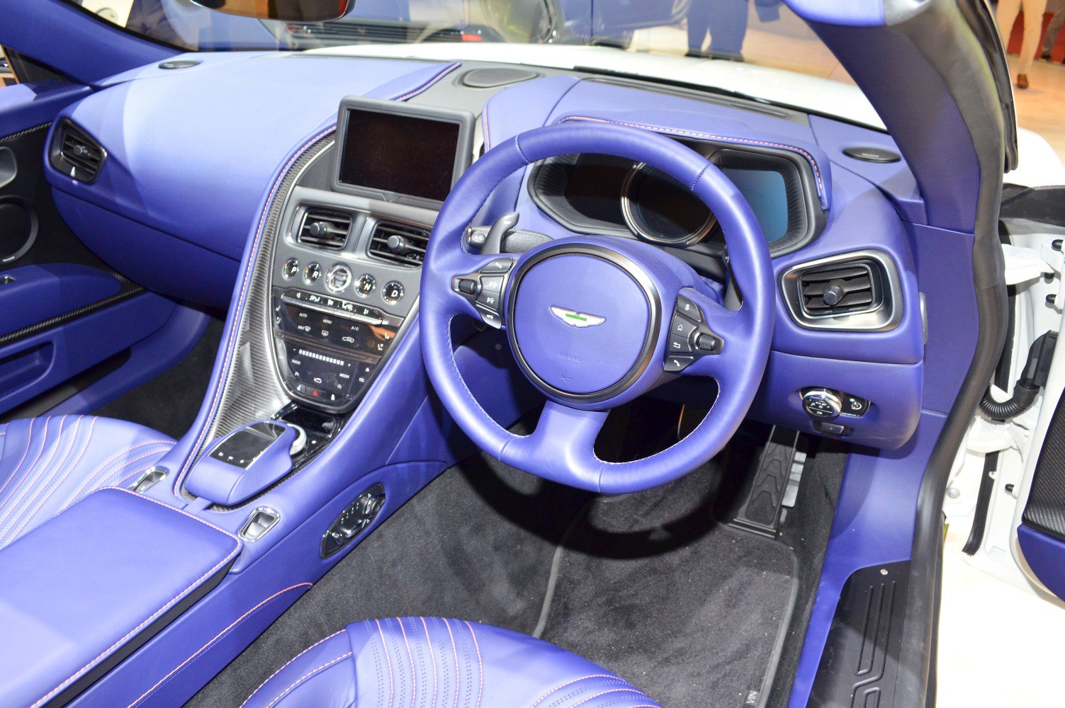 Luxury dashboard and leather steering wheel in blue interior