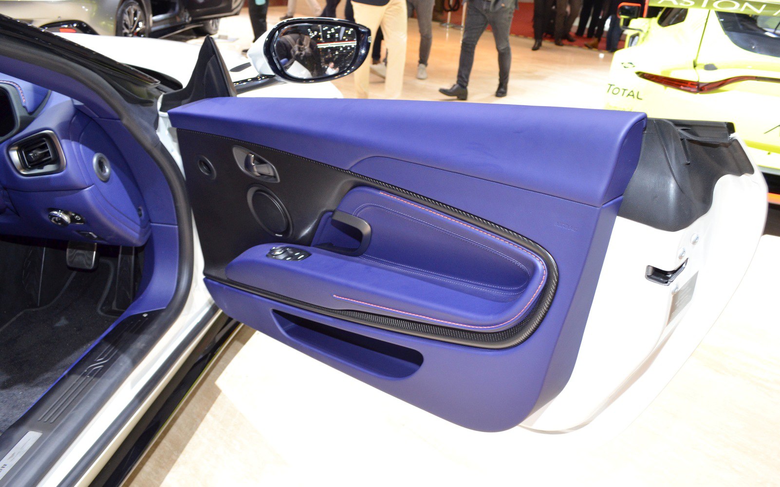 Luxury blue leather interior door panel with controls and speaker