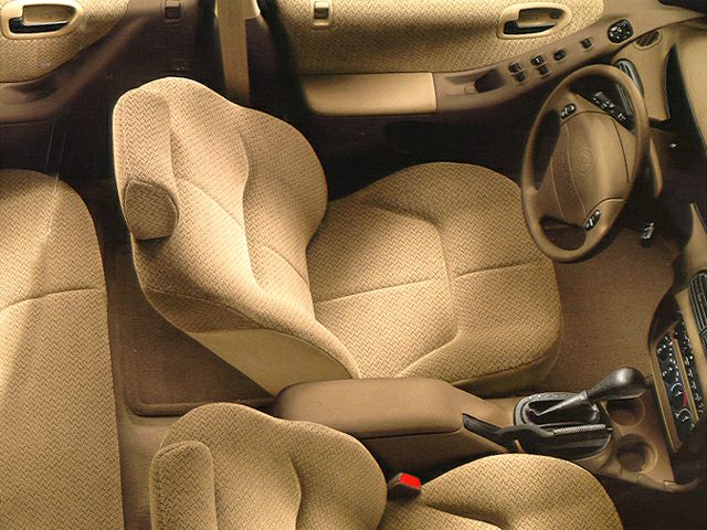 Beige fabric seats and dashboard with steering wheel and center console.