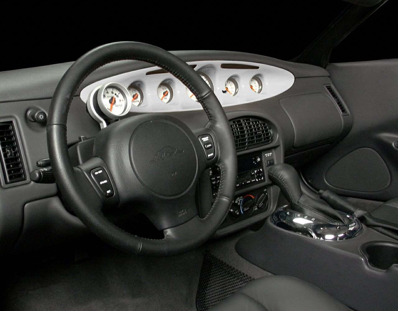 Retro white-faced gauges and leather steering wheel with controls
