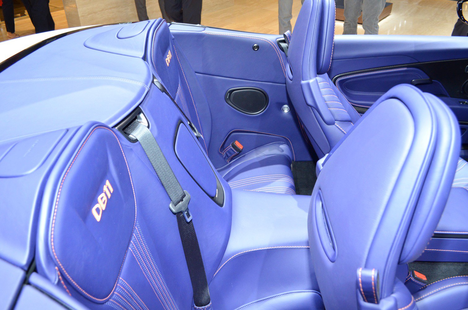 Blue leather convertible rear seats with detailed stitching and seat belts