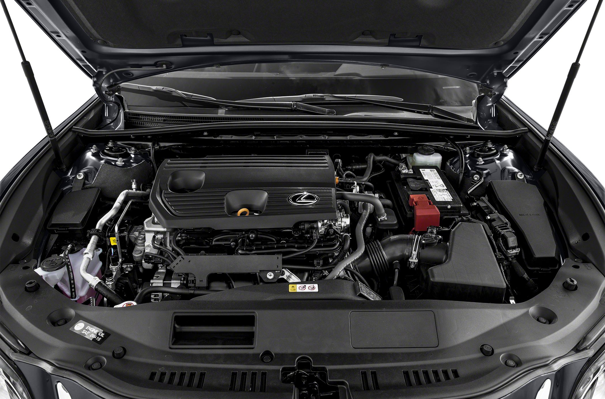 Engine bay with covered inline engine and visible components under hood