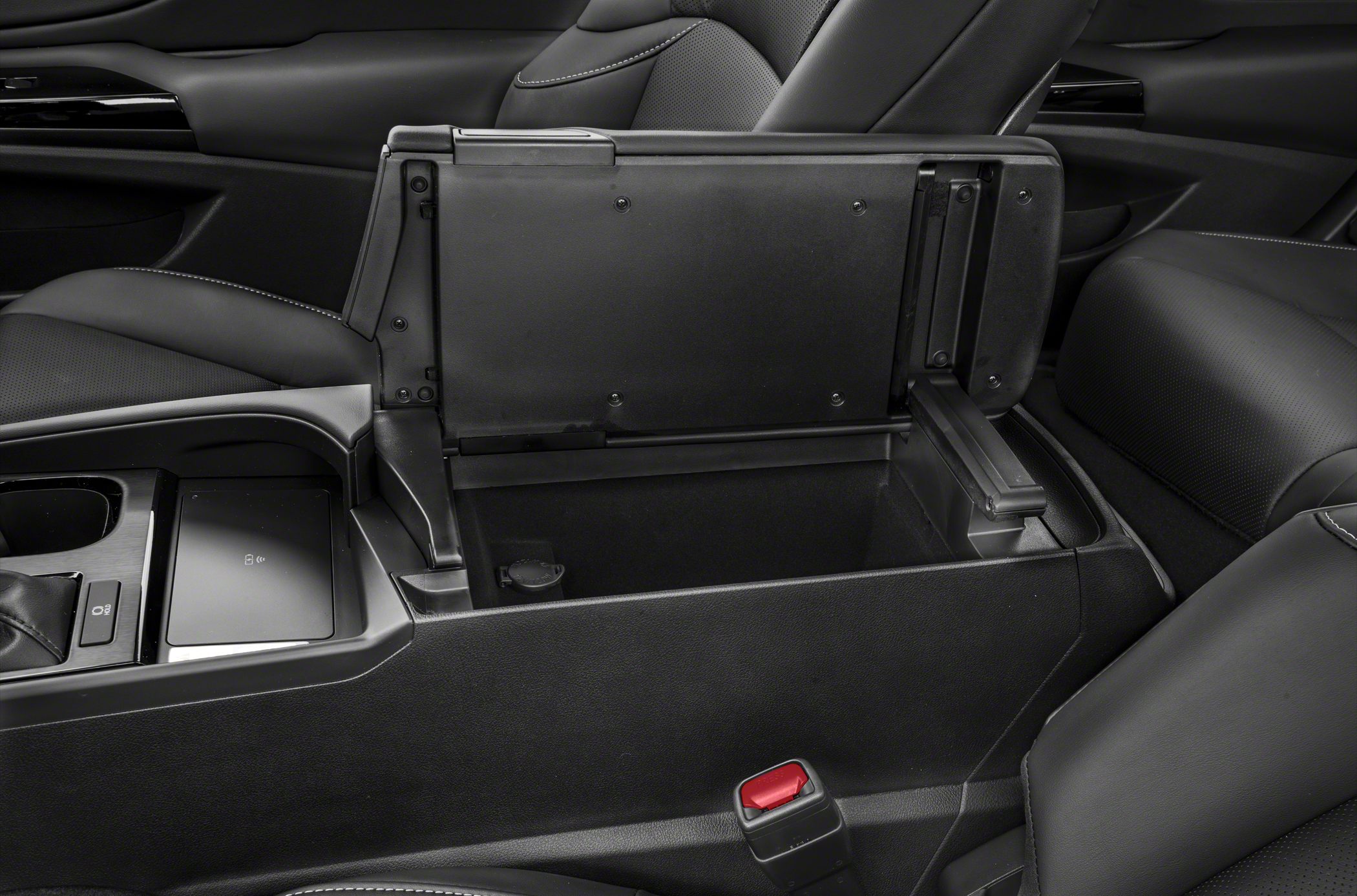 Center console storage compartment with wireless charging pad and leather seats.