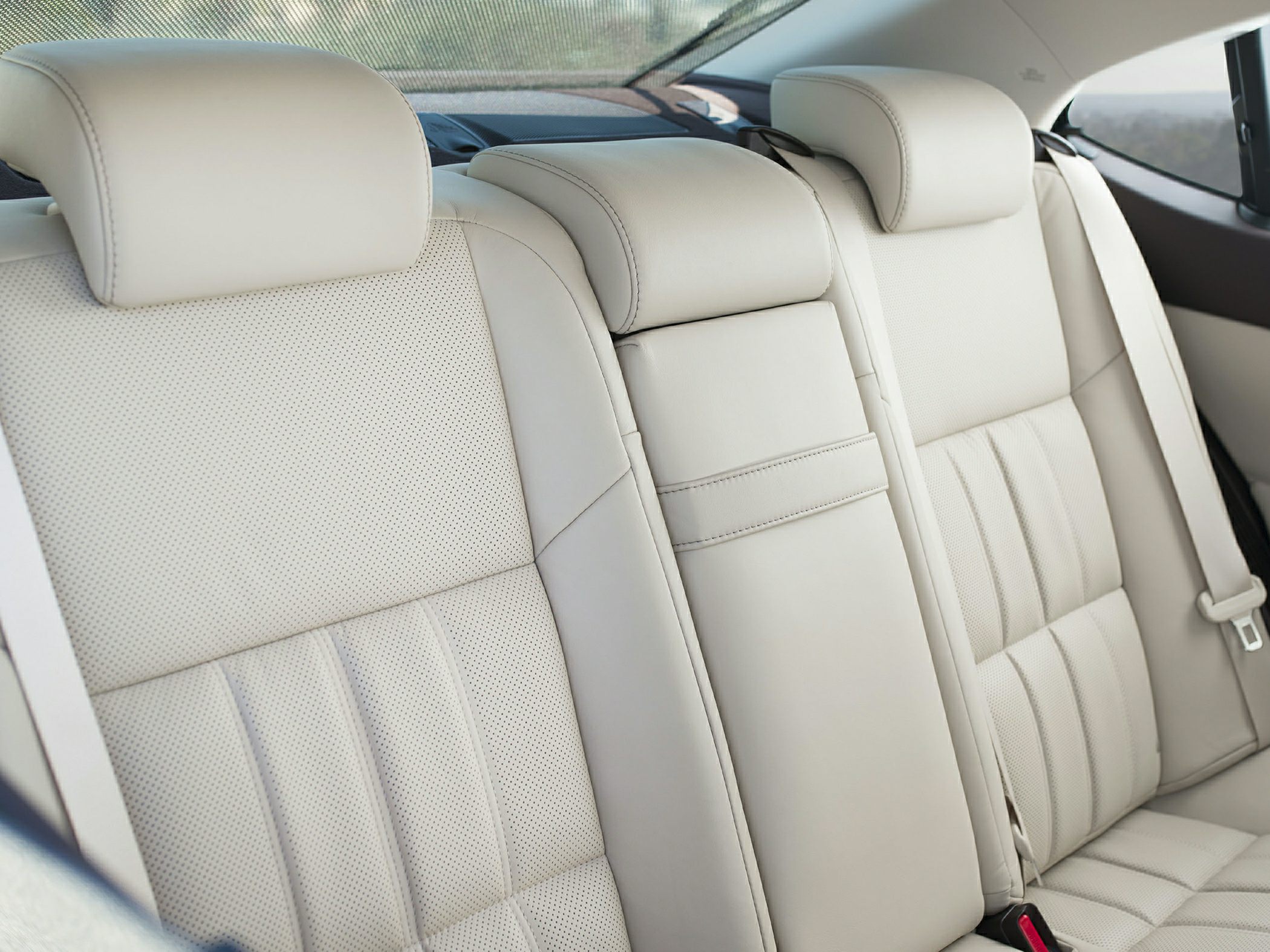 Beige leather rear seats with headrests and center armrest