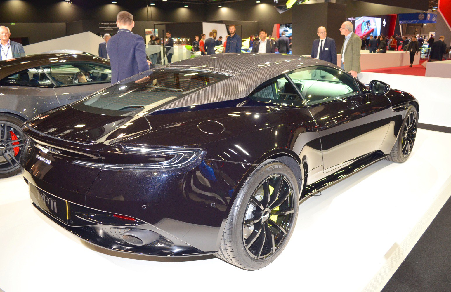 Rear view featuring carbon fiber roof and alloy wheels.