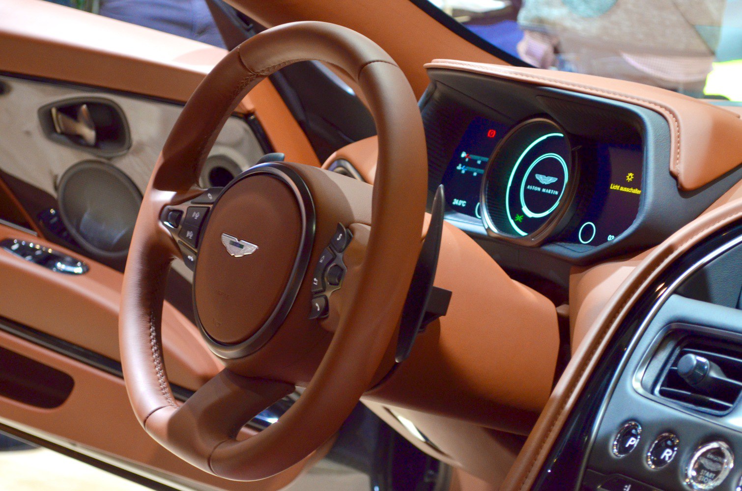 Leather steering wheel and digital instrument cluster in luxury car interior
