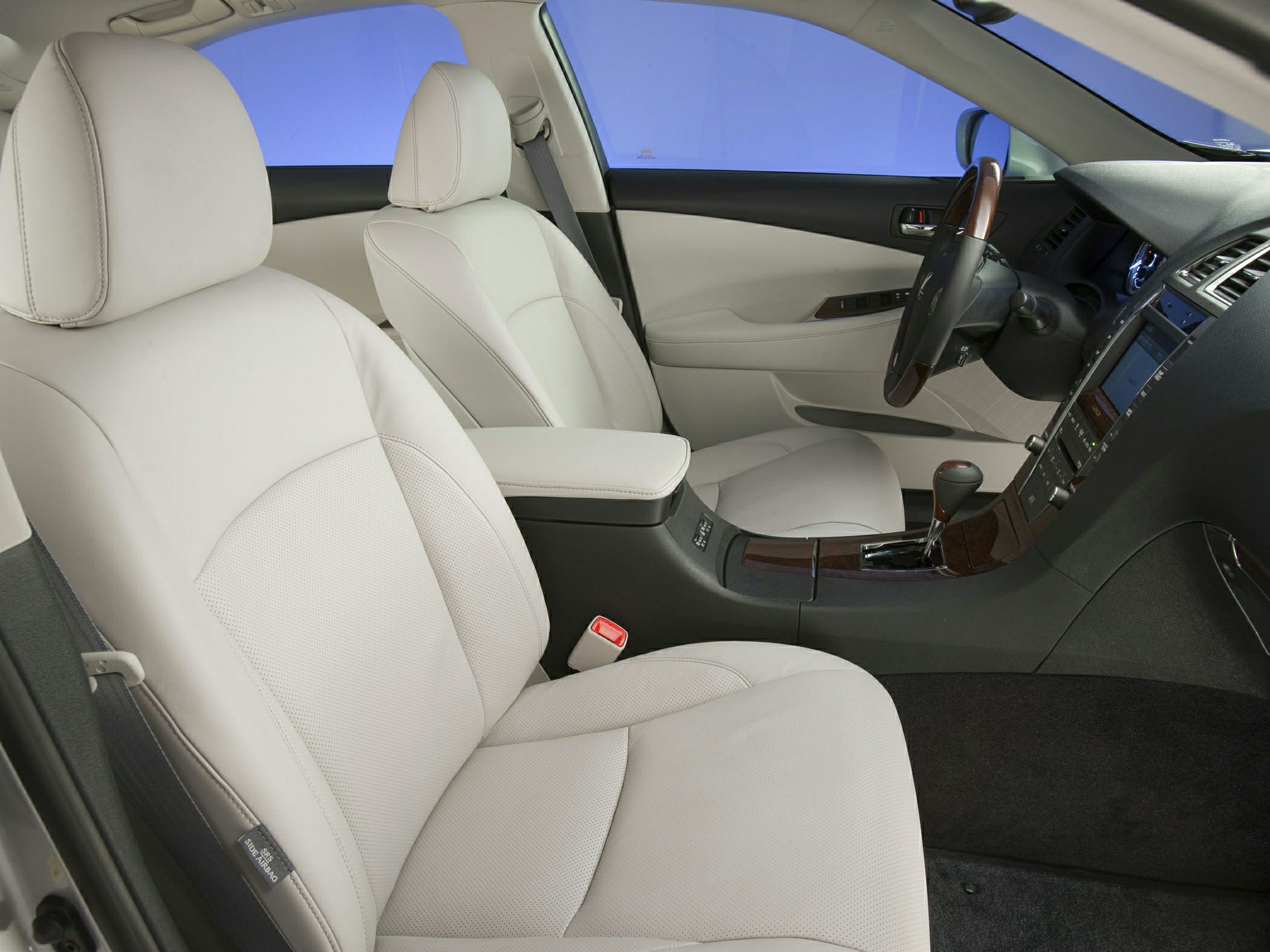 Front seats and dashboard with leather upholstery and wood trim
