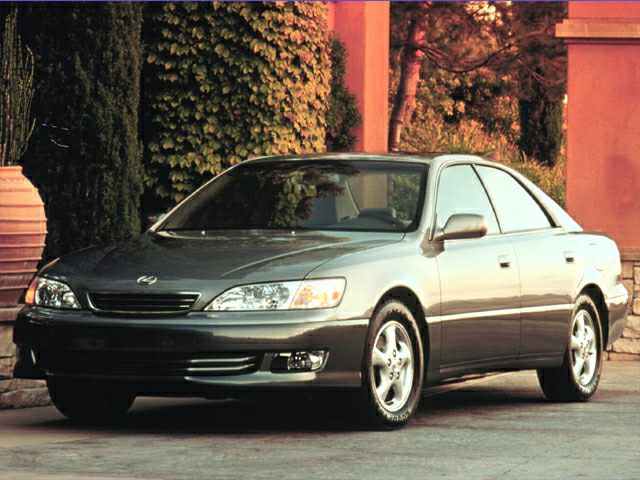 Front side view of a mid-90s four-door sedan with distinctive headlights and smooth body lines