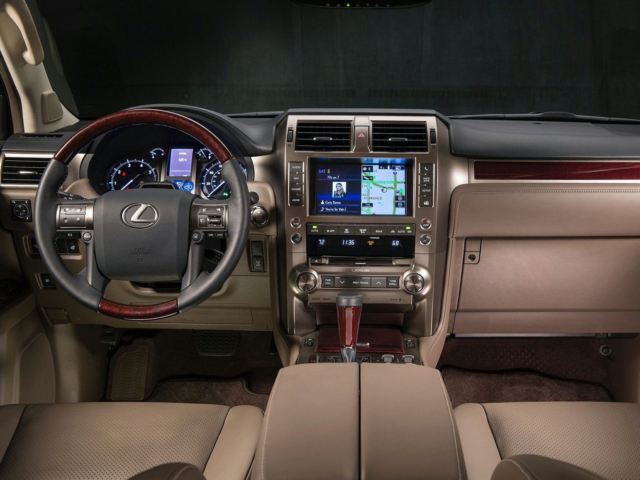 Luxury car interior with leather, wood trim, digital dashboard, and navigation screen