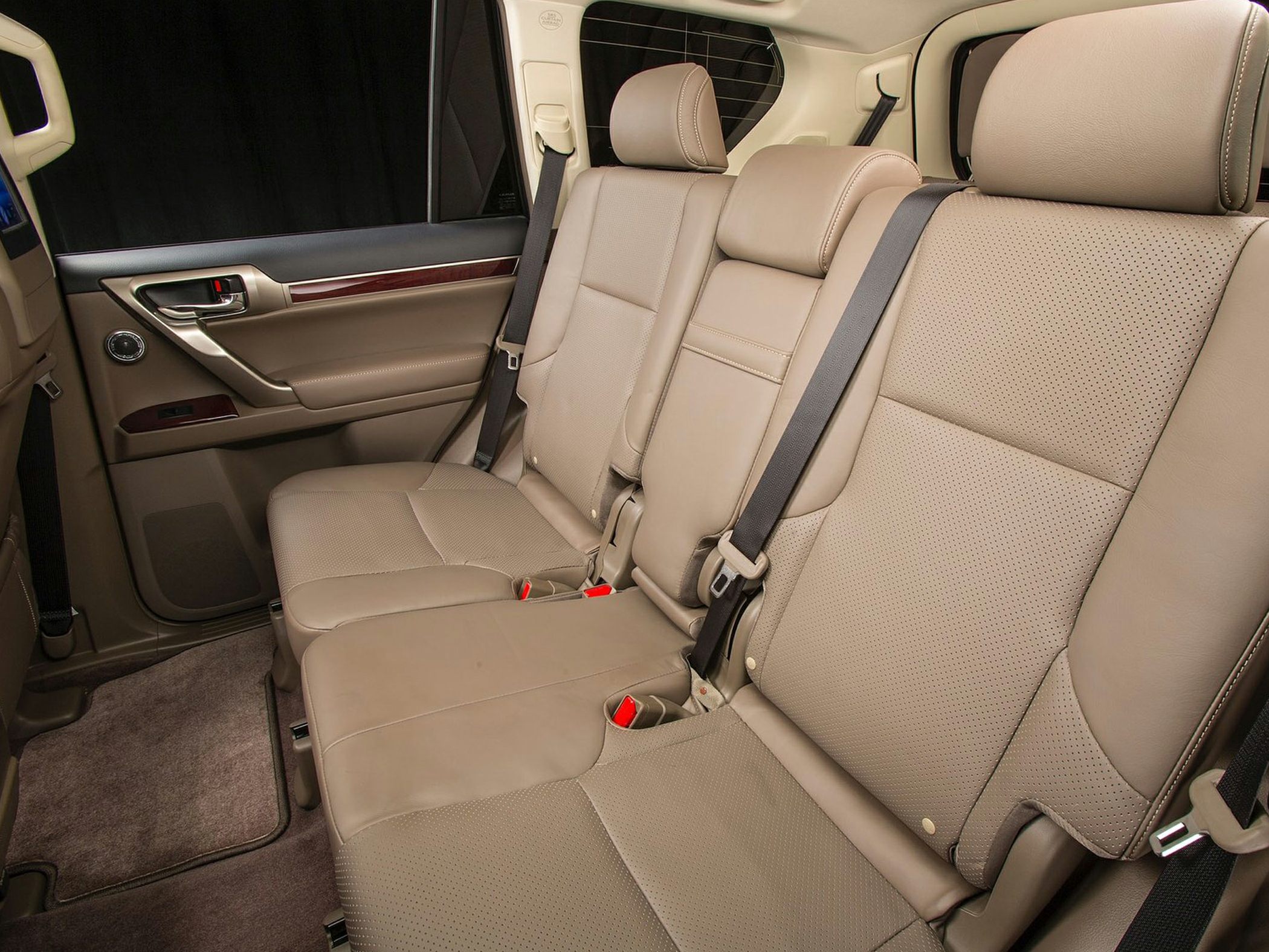 Beige perforated leather rear seats with headrests and seat belts