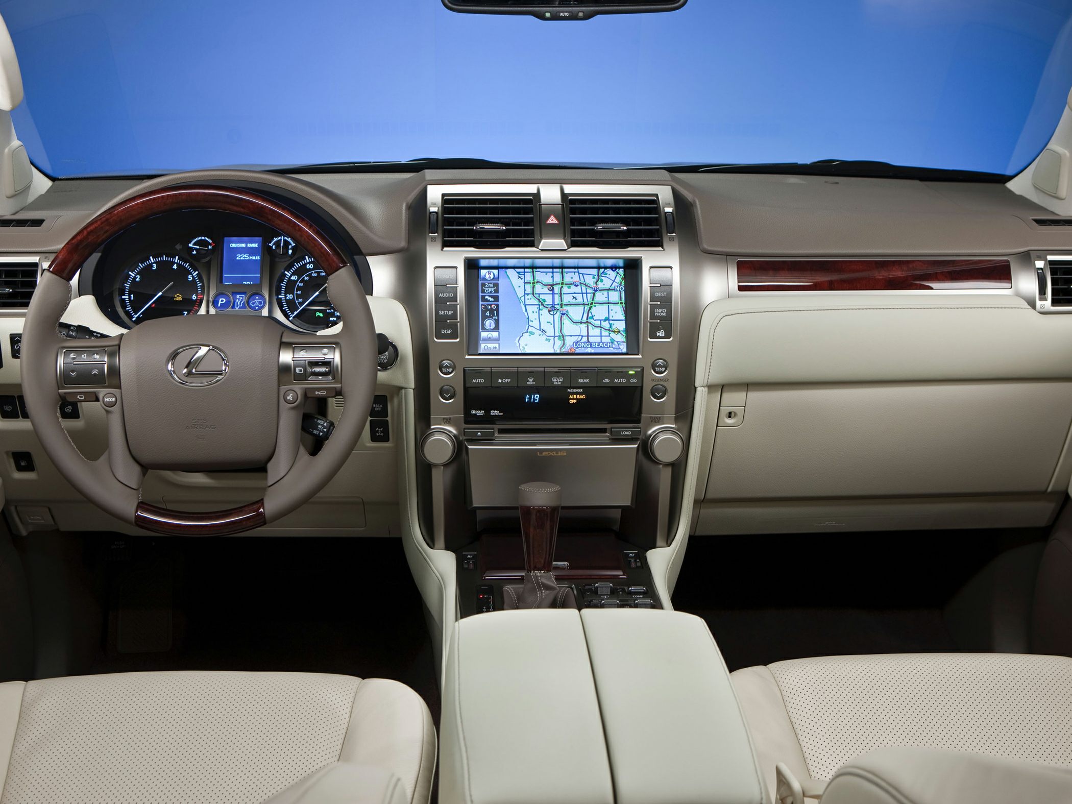 Luxury SUV dashboard with navigation display and wood-accented steering wheel