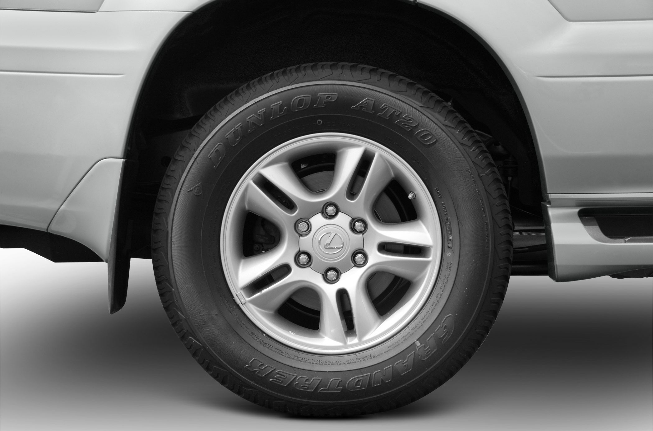 Closeup of alloy wheel with Dunlop AT20 tire mounted on vehicle