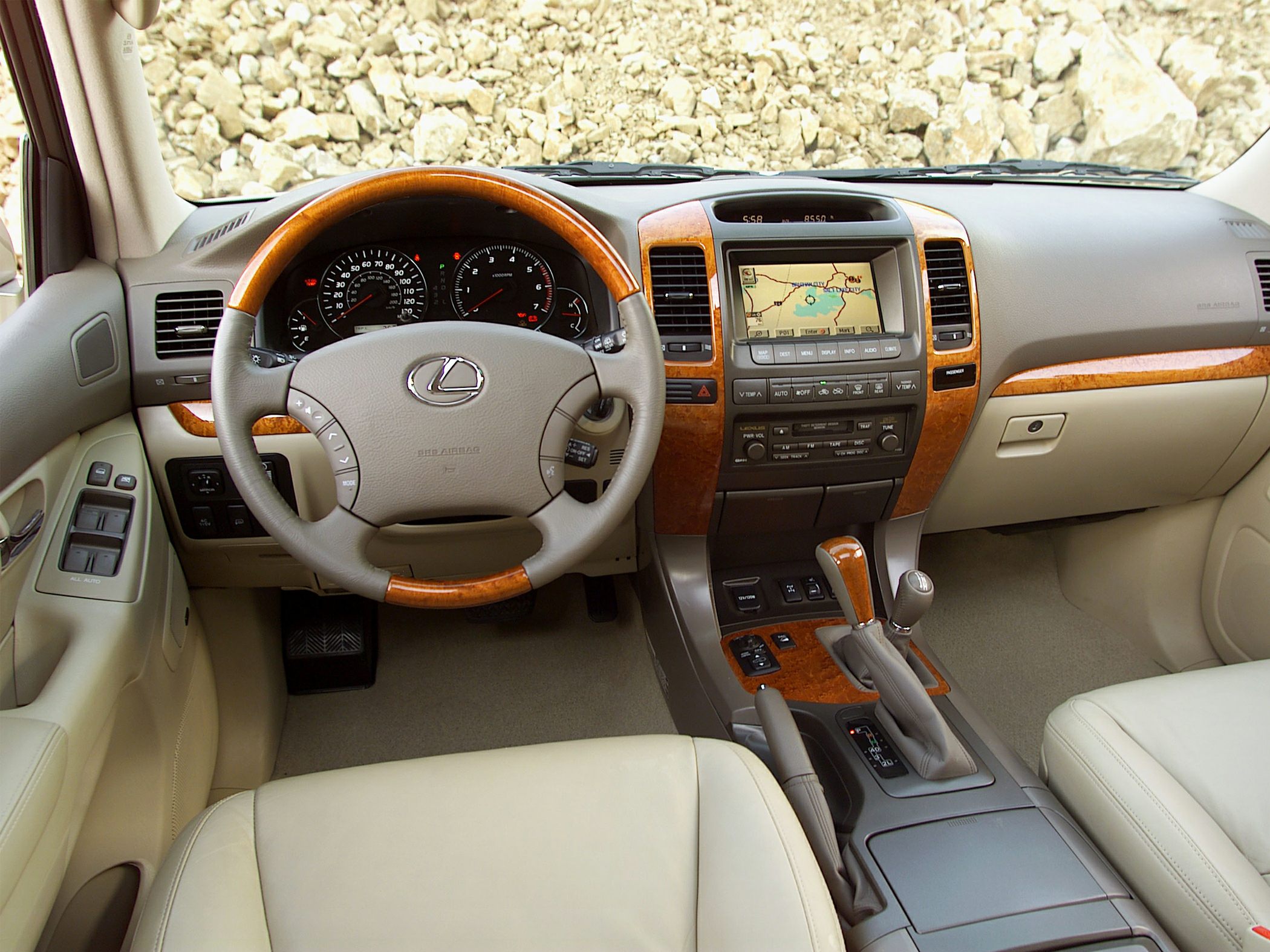 Interior dashboard with wood trim, leather seats, and navigation display