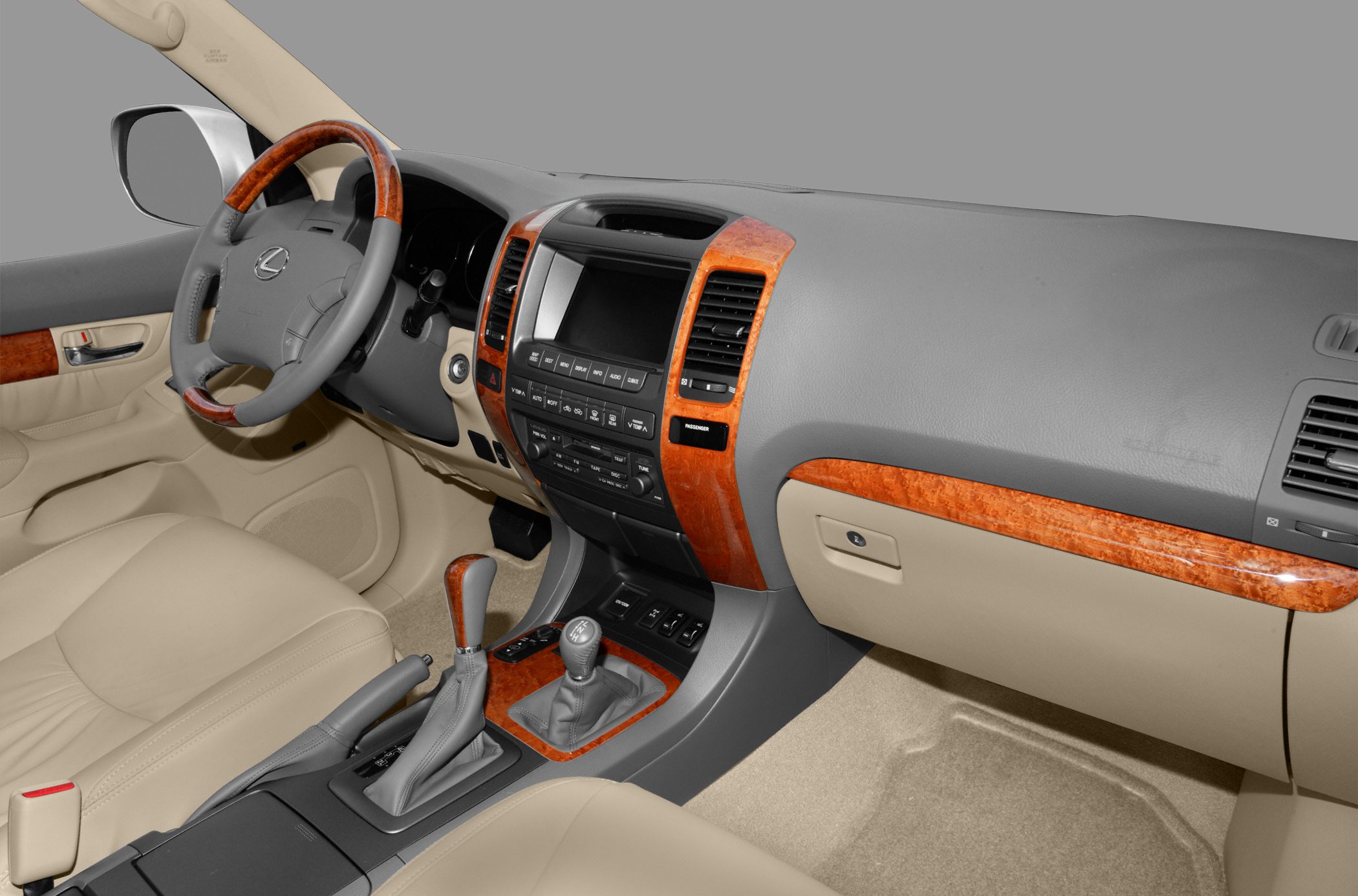 Luxury SUV interior with wood trim and manual gear shifter