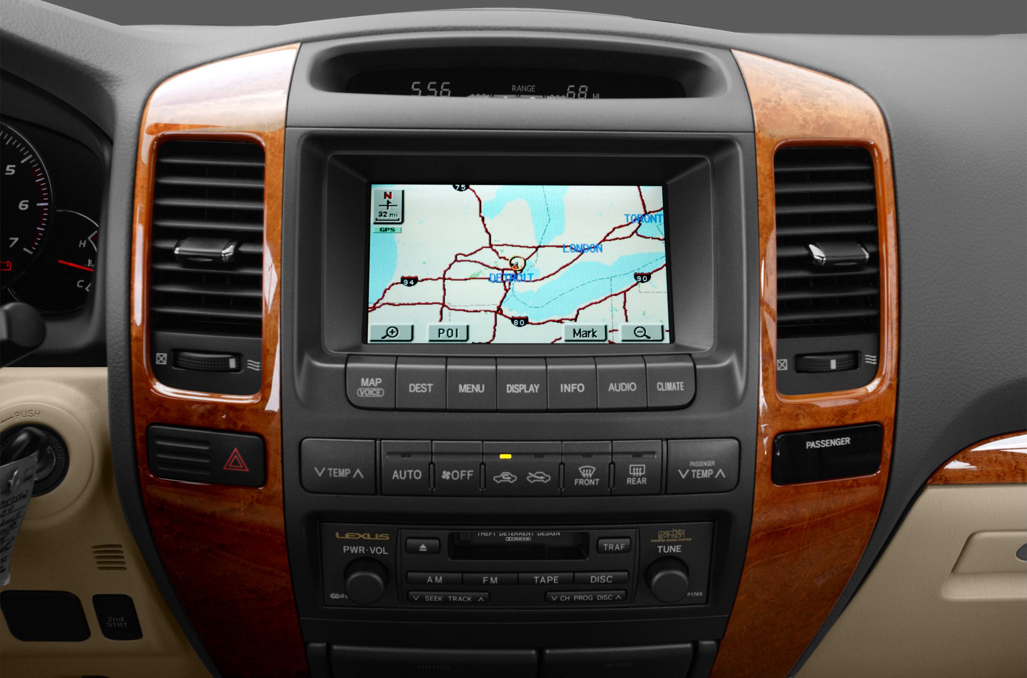 Car dashboard with navigation screen and climate control buttons, wood trim.