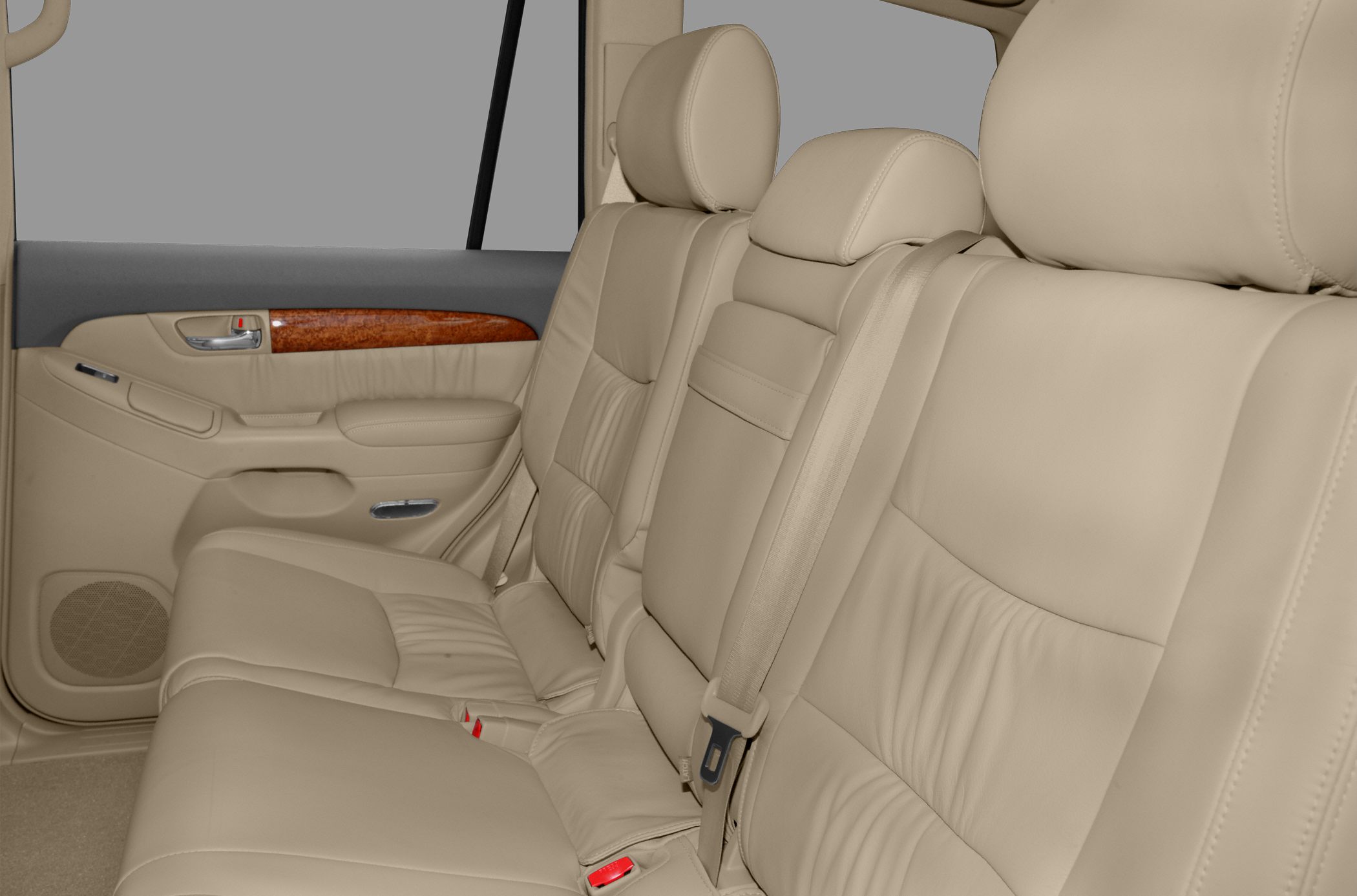 Beige leather rear seats with wood trim and seat belts