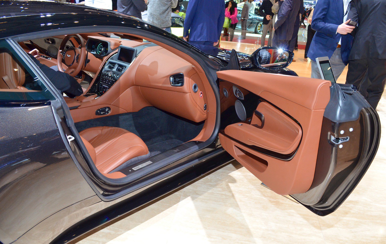 Luxurious brown leather interior with detailed dashboard and door panel.