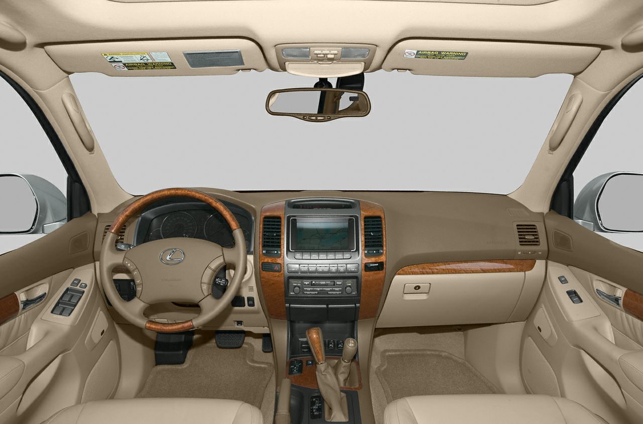 Beige car interior with wood-trimmed steering wheel and central navigation screen