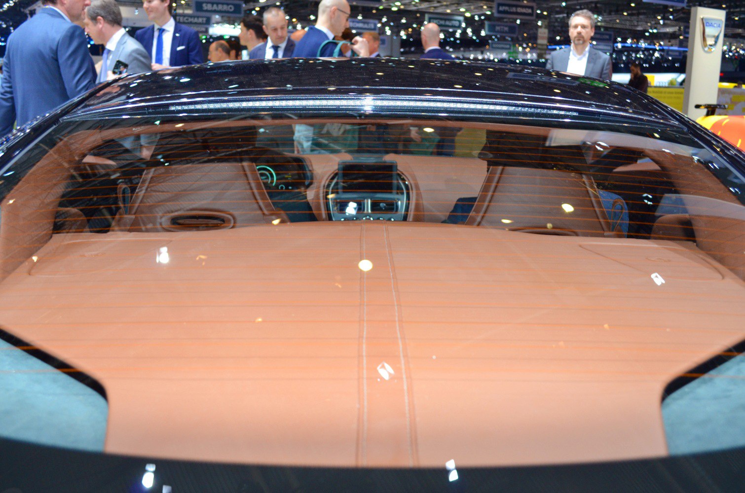 Rear interior leather upholstery with central dashboard visible