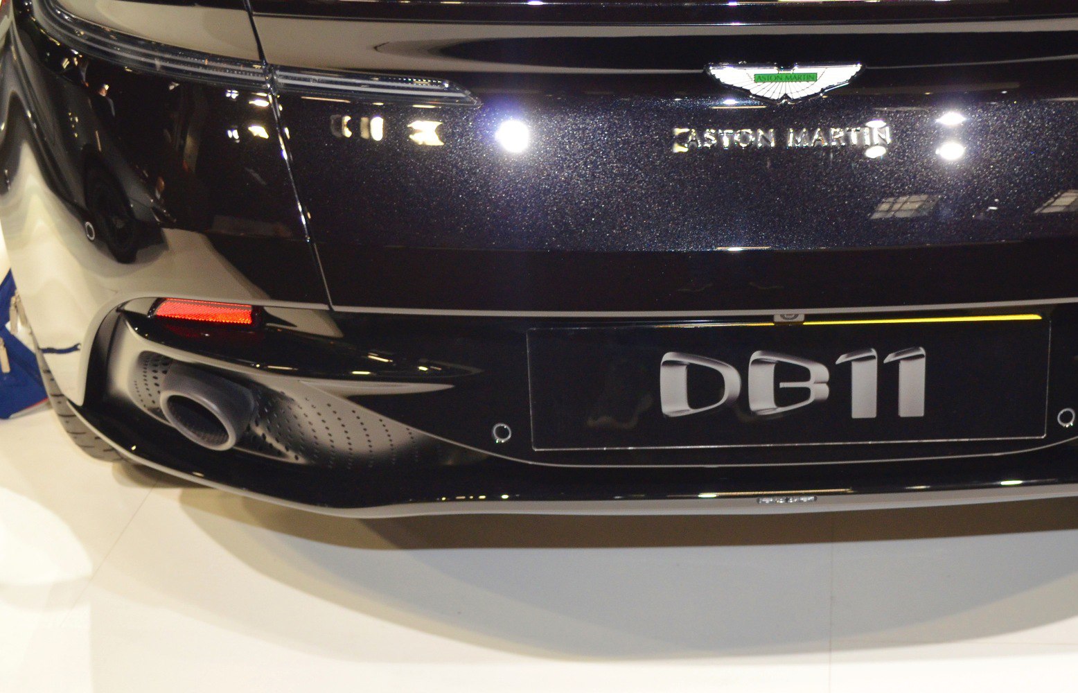 Close-up of rear exhaust, badge, and model name plate