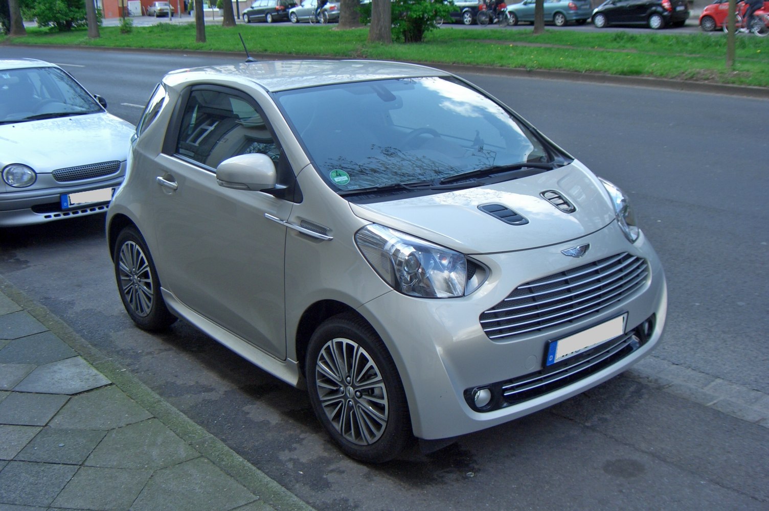 Front-side view of a compact hatchback with distinctive grille and hood vents