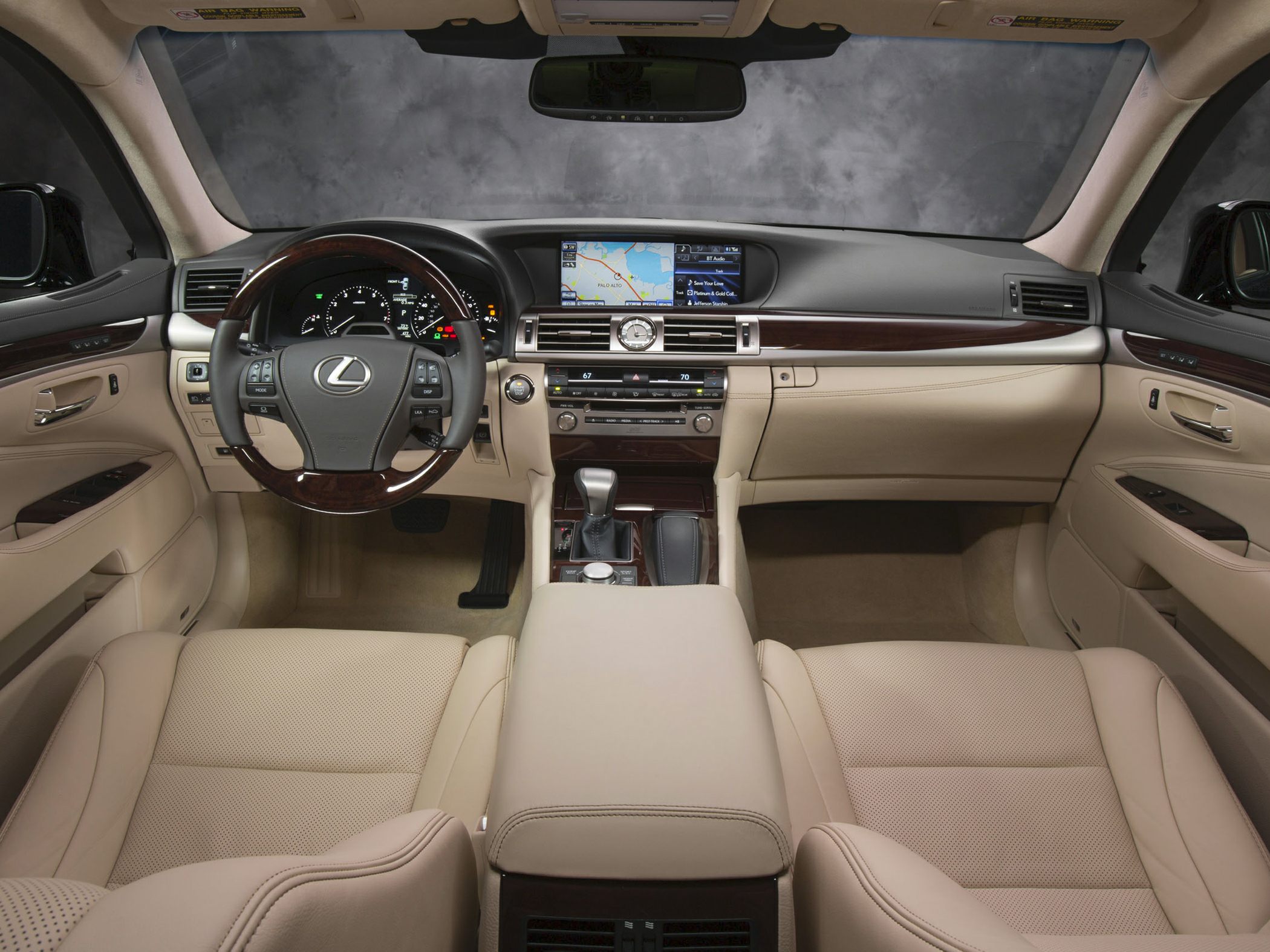 Luxury beige leather seats with wood trim dashboard and modern digital display