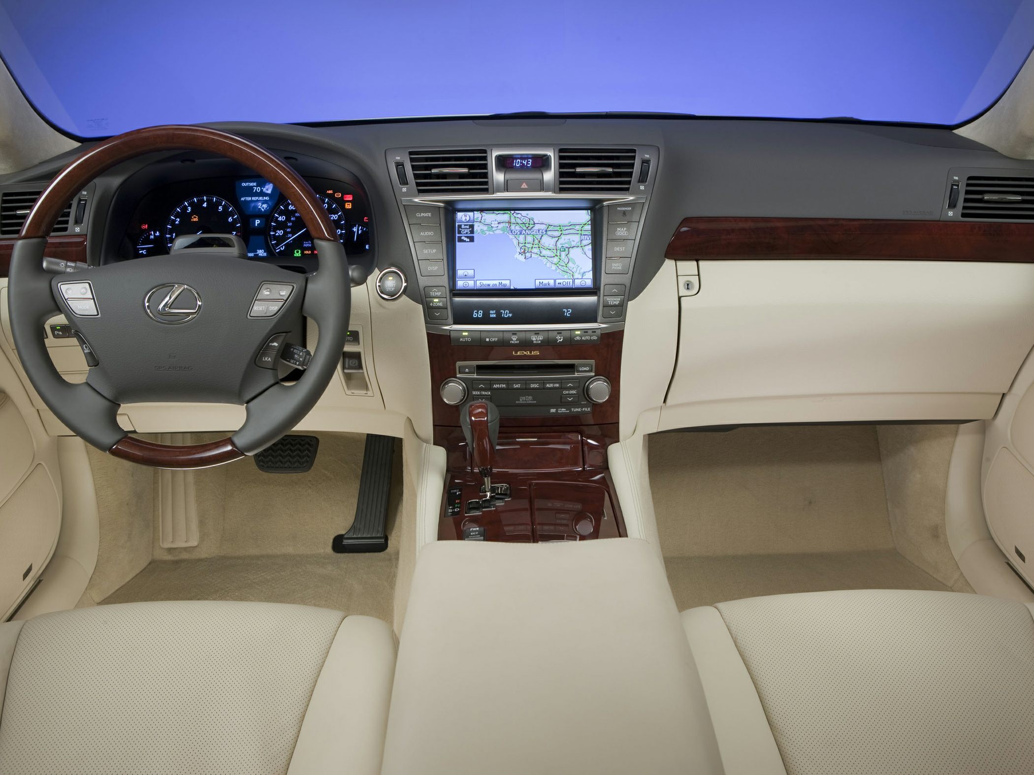 Luxury interior with wood trim steering wheel and digital navigation display