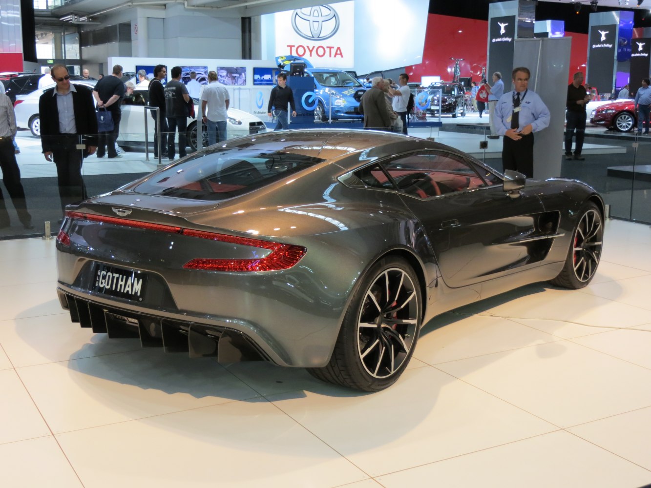 Rear view of a sleek sports coupe with distinctive taillights and sporty multi-spoke wheels.