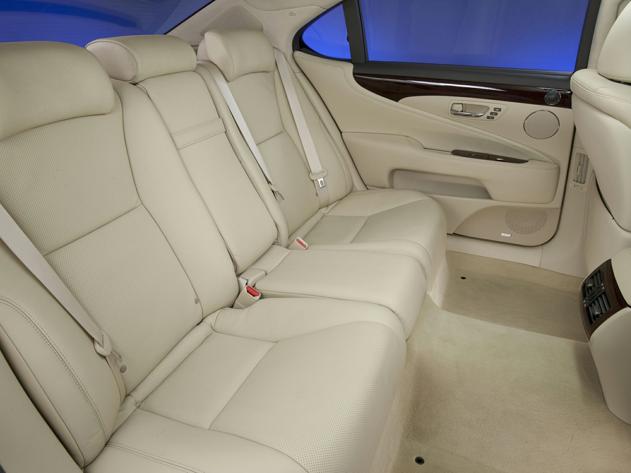 Beige leather rear passenger seats with wood trim door panel