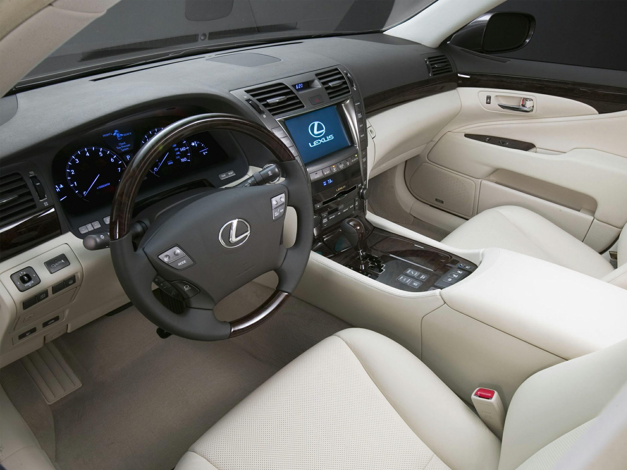 Luxury beige leather interior with wood trim and advanced dashboard