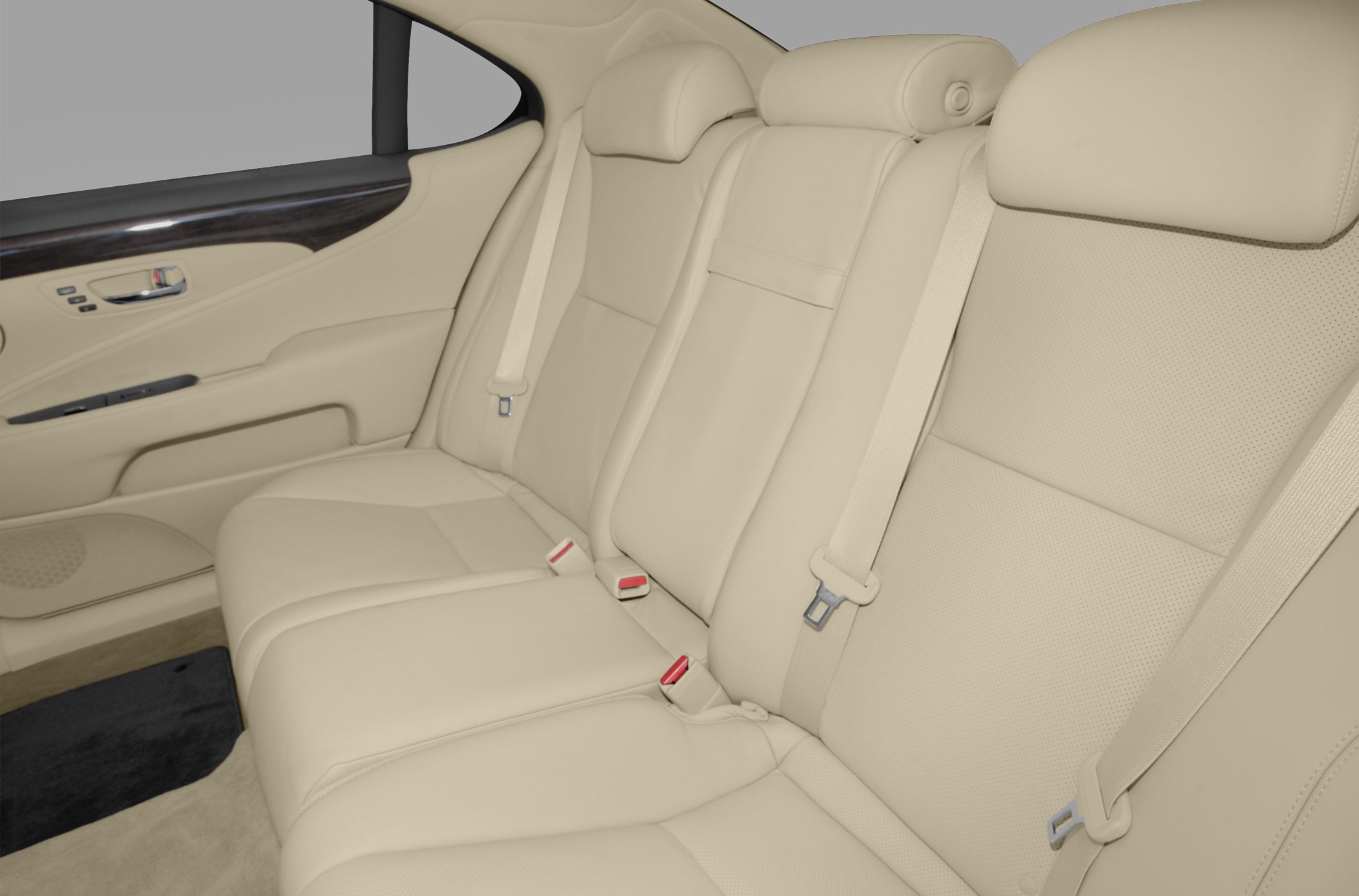 Beige leather rear seats with integrated seat belts and wood-trimmed door panel