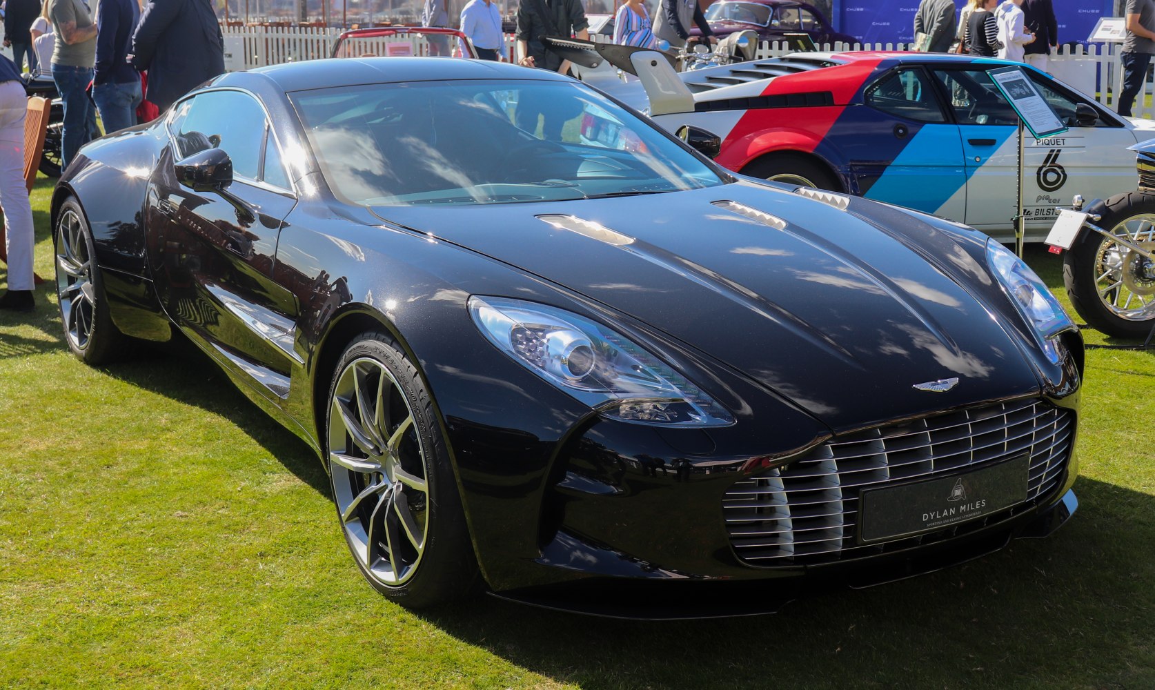 Sleek black supercar with large front grille and stylish multi-spoke alloy wheels