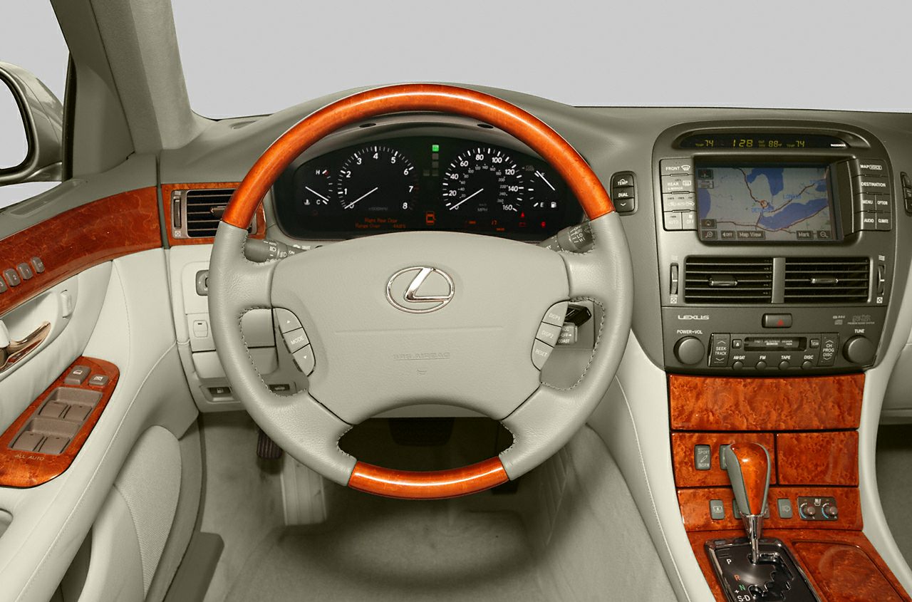Luxurious car interior with wood-trimmed steering wheel and dashboard