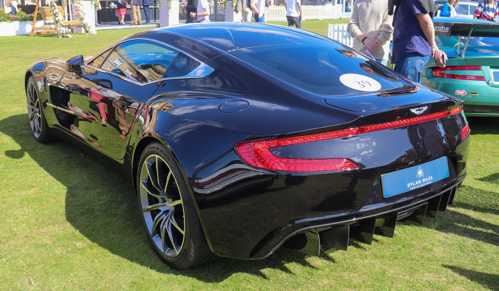 Rear view showing diffuser and LED taillights on sleek black sports car