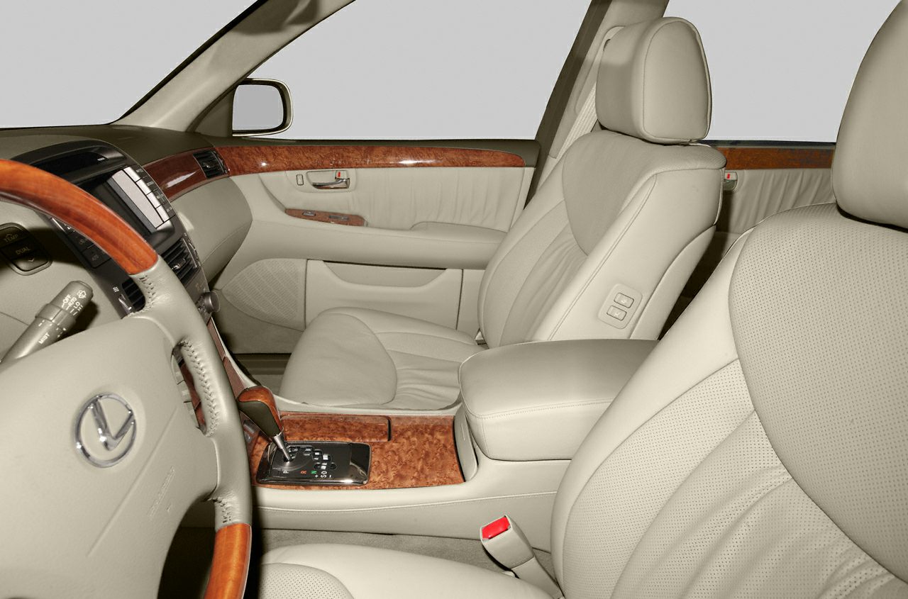 Beige leather seats and wood trim interior with automatic gear lever