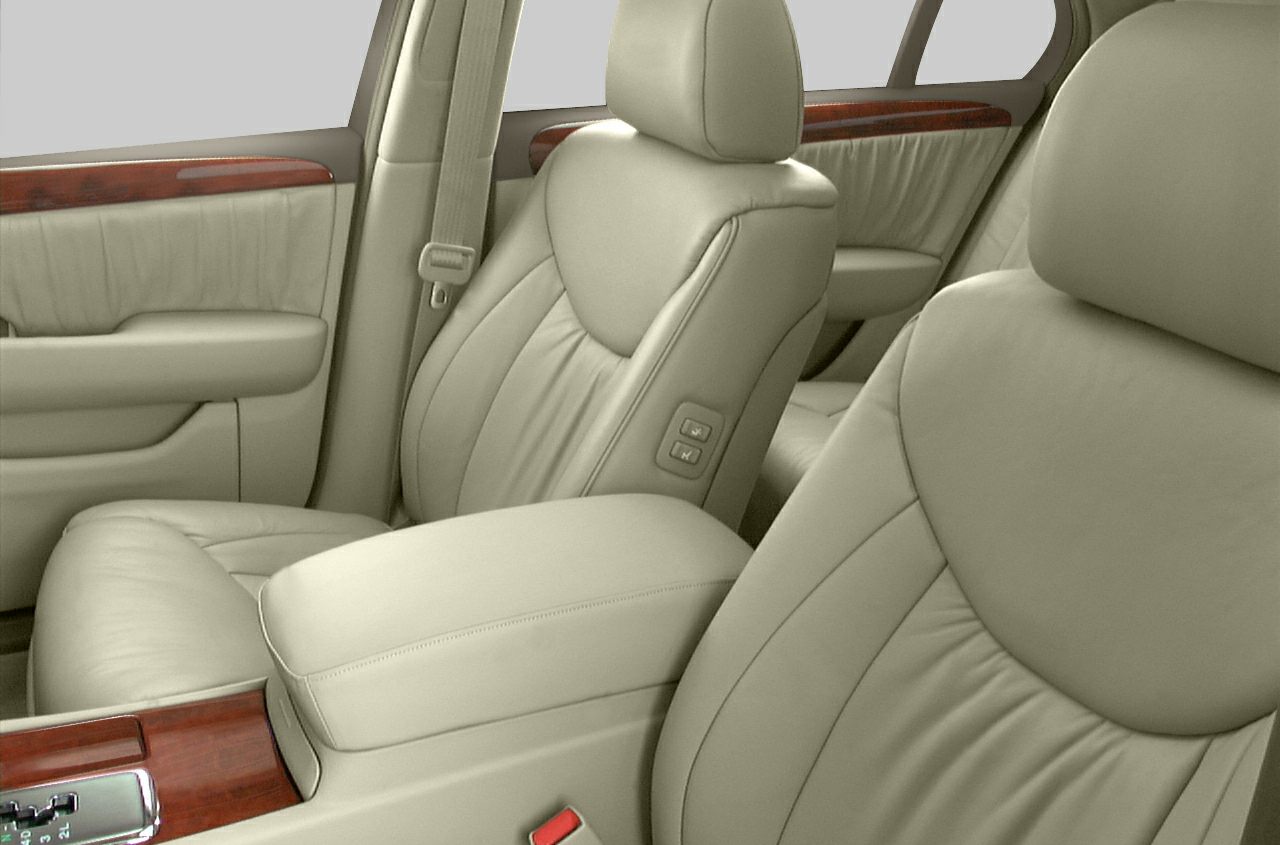 Beige leather seats with wood trim and detailed stitching