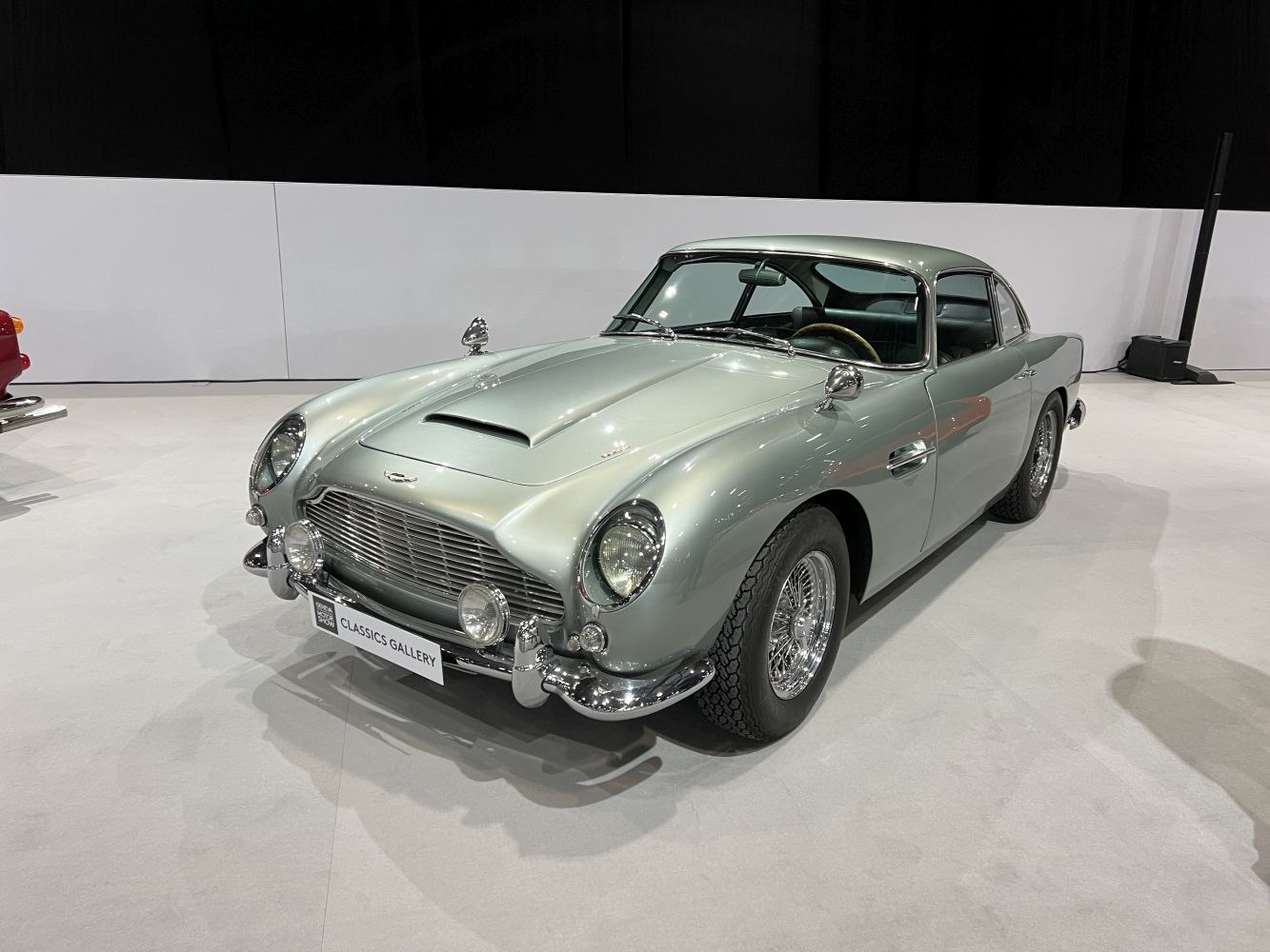 Classic car front view with iconic grille, round headlights, chrome bumper.