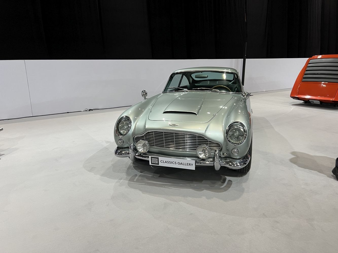 Classic silver vintage car front with grille and round headlights