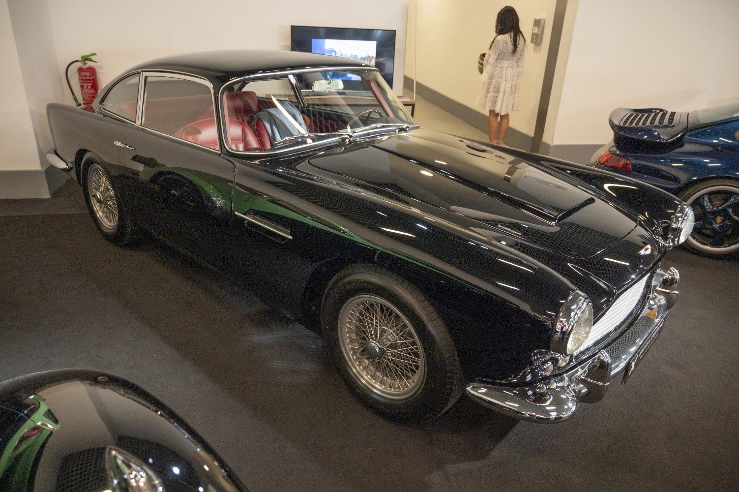 Black luxury coupe with chrome bumpers and wire-spoke wheels