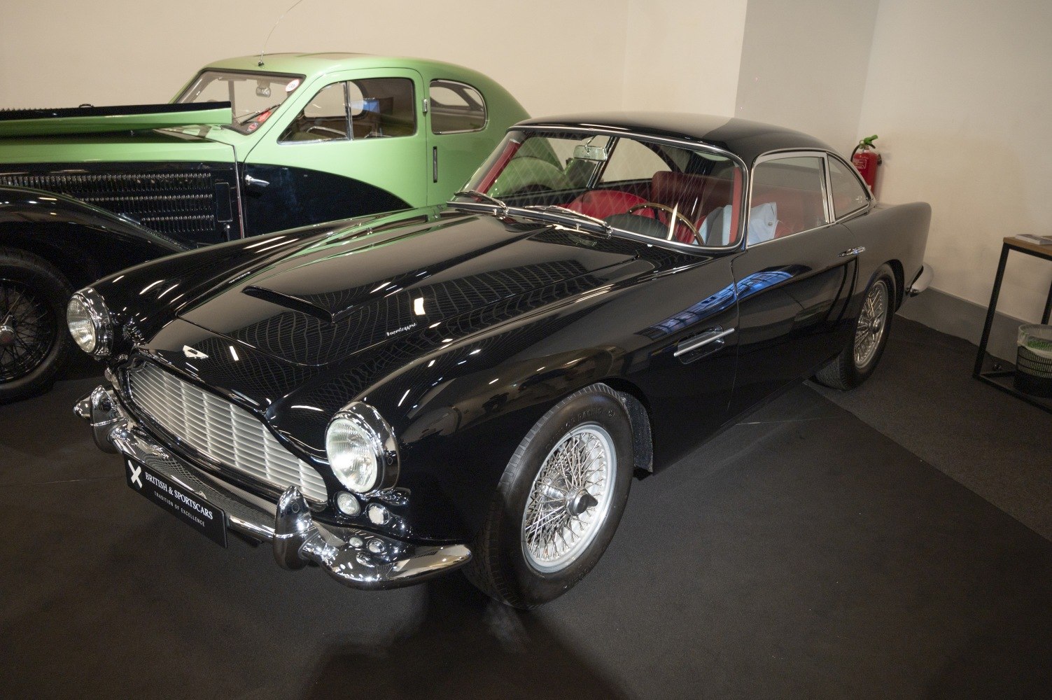 Vintage coupe with wire spoke wheels and elegant curved body.