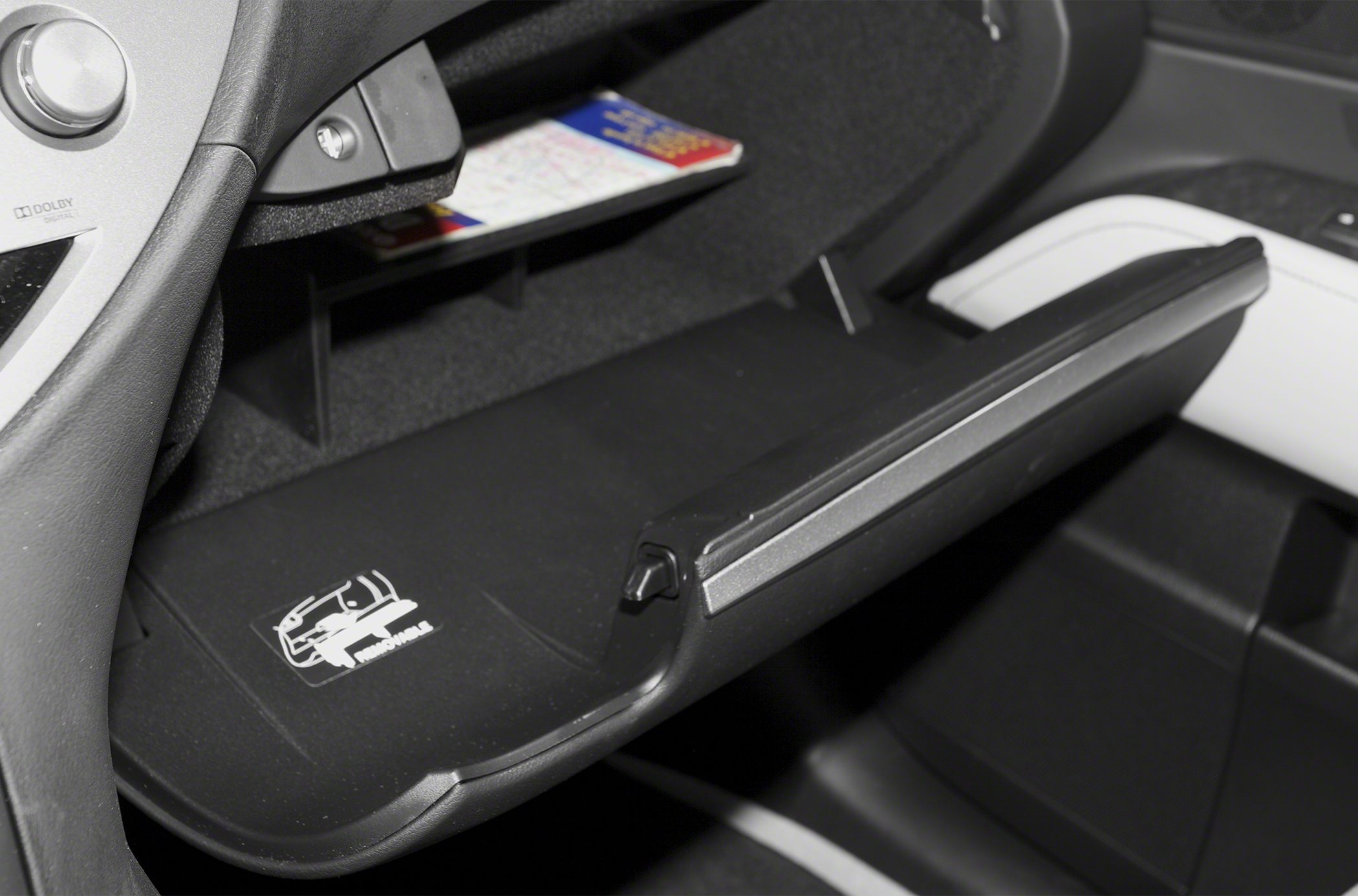 Open glove compartment with interior storage details inside vehicle cabin