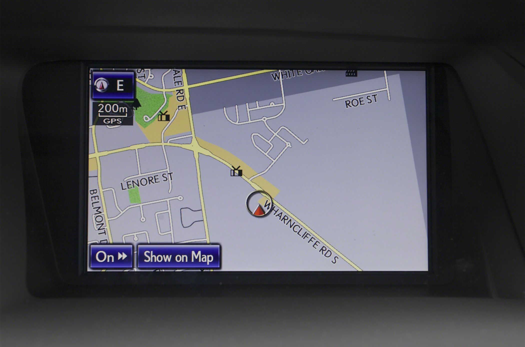 In-dash navigation system map interface with road names and directional marker