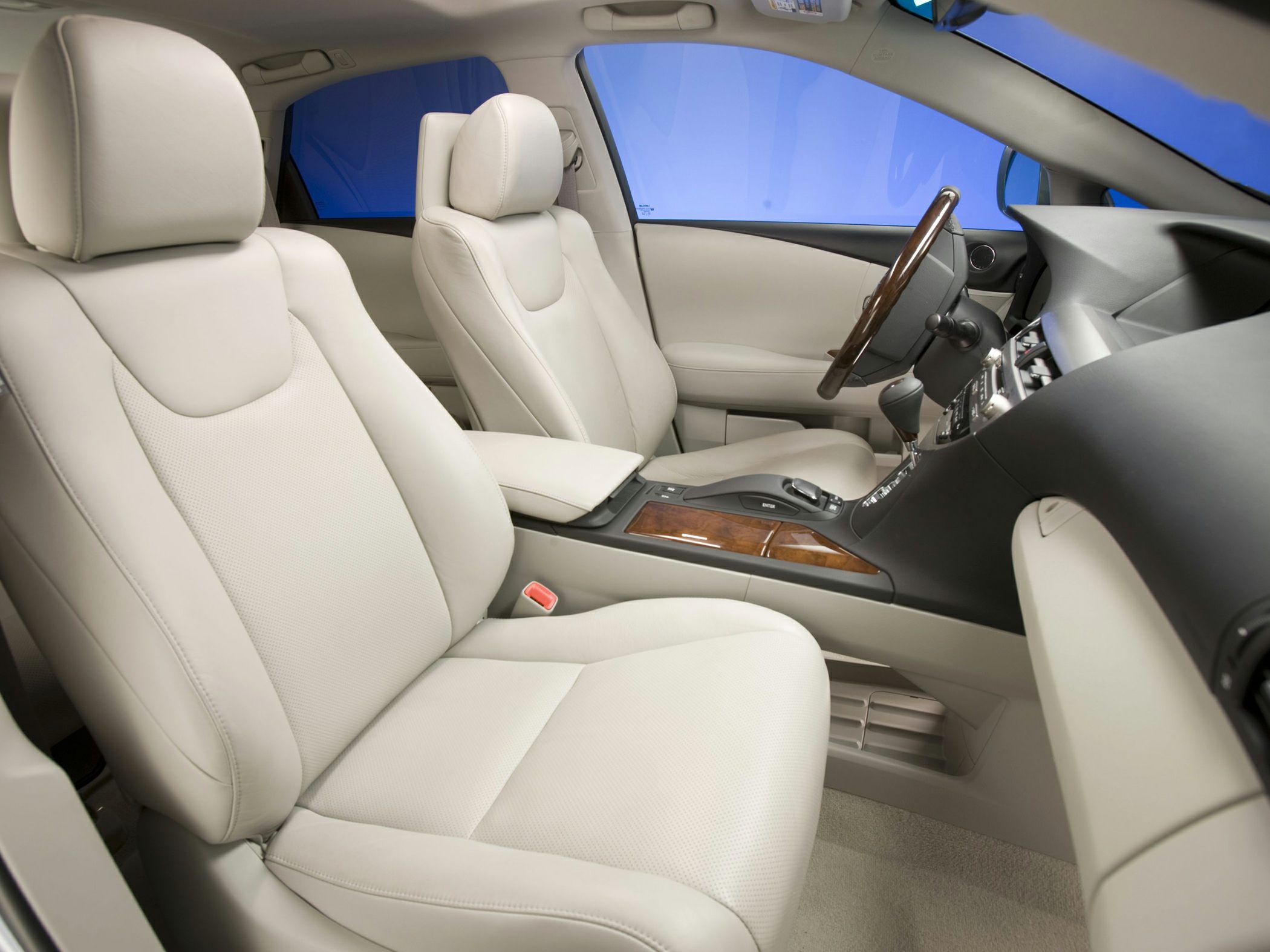 Beige leather seats with wooden trim center console and detailed dashboard