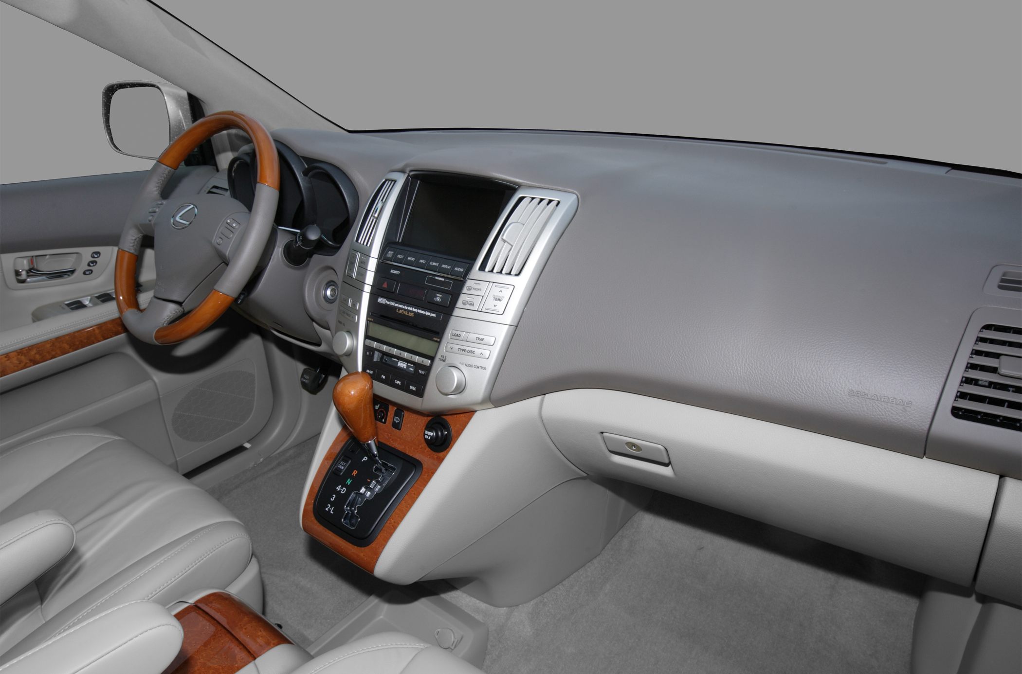 Wood trim steering wheel and gear shifter with central dashboard display