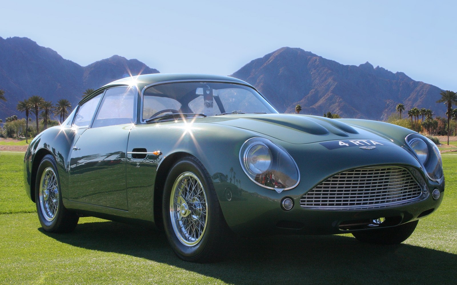 Aerodynamic vintage sports coupe with wire wheels and elliptical headlights
