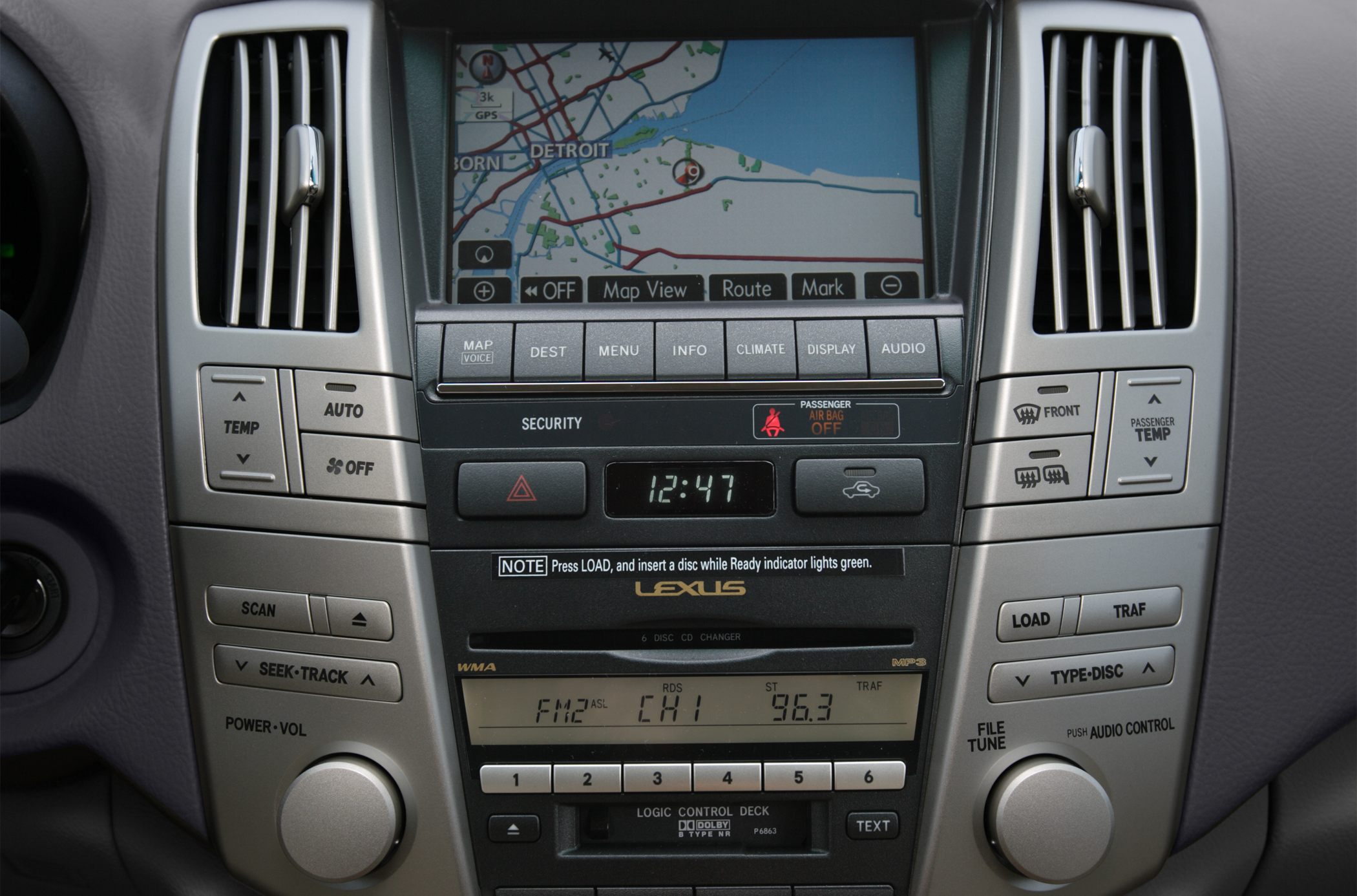 Car navigation screen and climate control panel with audio system interface.