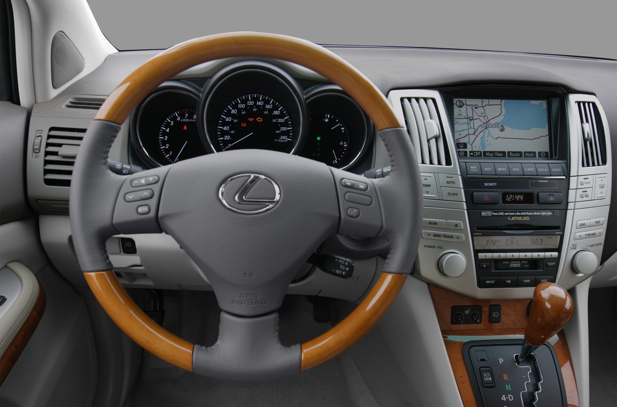 Wooden-trimmed steering wheel with integrated controls and central dashboard with GPS display