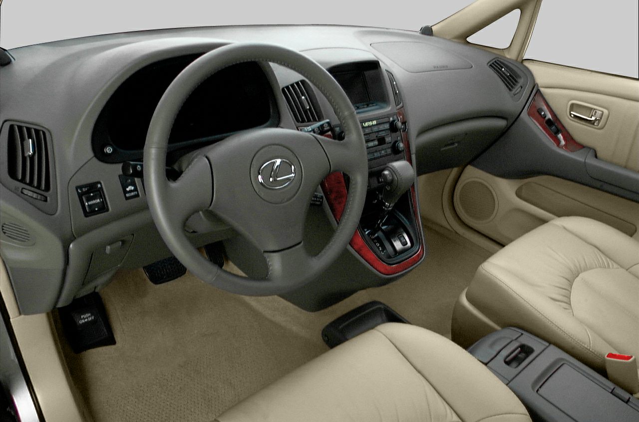 Leather steering wheel and wood accent dashboard with beige leather seats