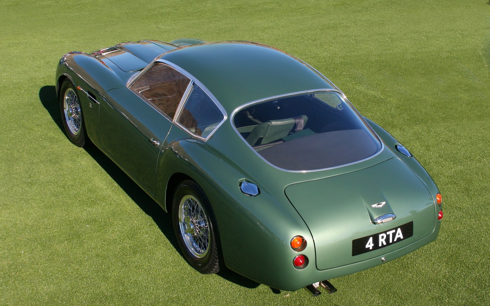 Rear view of classic 1960 vintage with wire wheels and smooth curved roofline